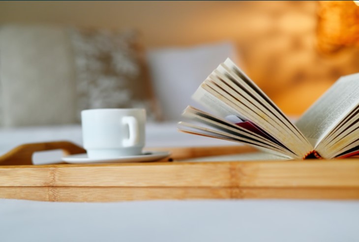 A simple, calming photo of a book next to a cup of herbal tea symbolizing a bedtime routine.